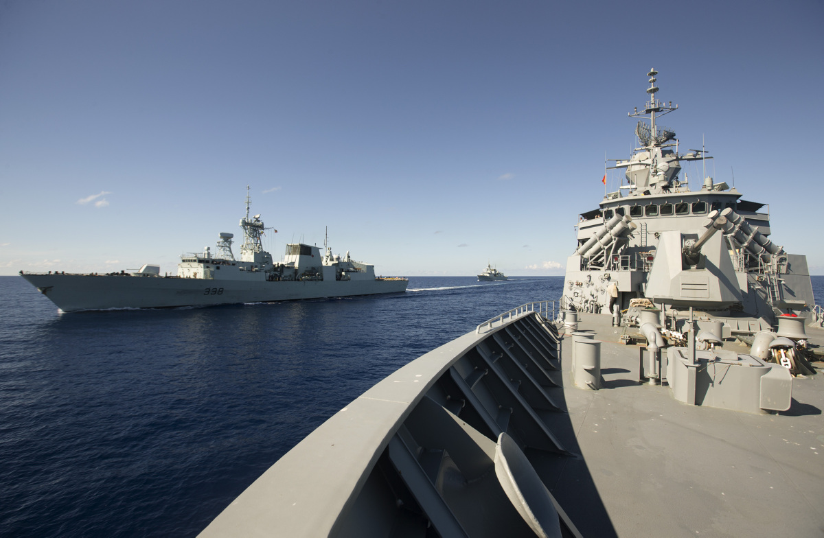 Two naval ships on the open water