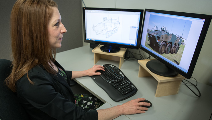 Team member working on computer rendering of a land vehicle