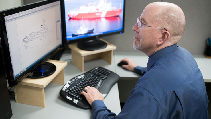 Engineer working on computer rendering of a ship