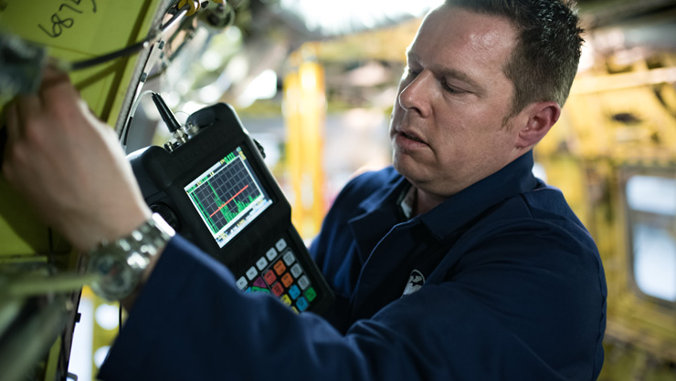 Engineer performing quality control on a piece of equipment